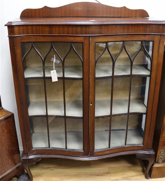 A serpentine china display cabinet, W.99cm